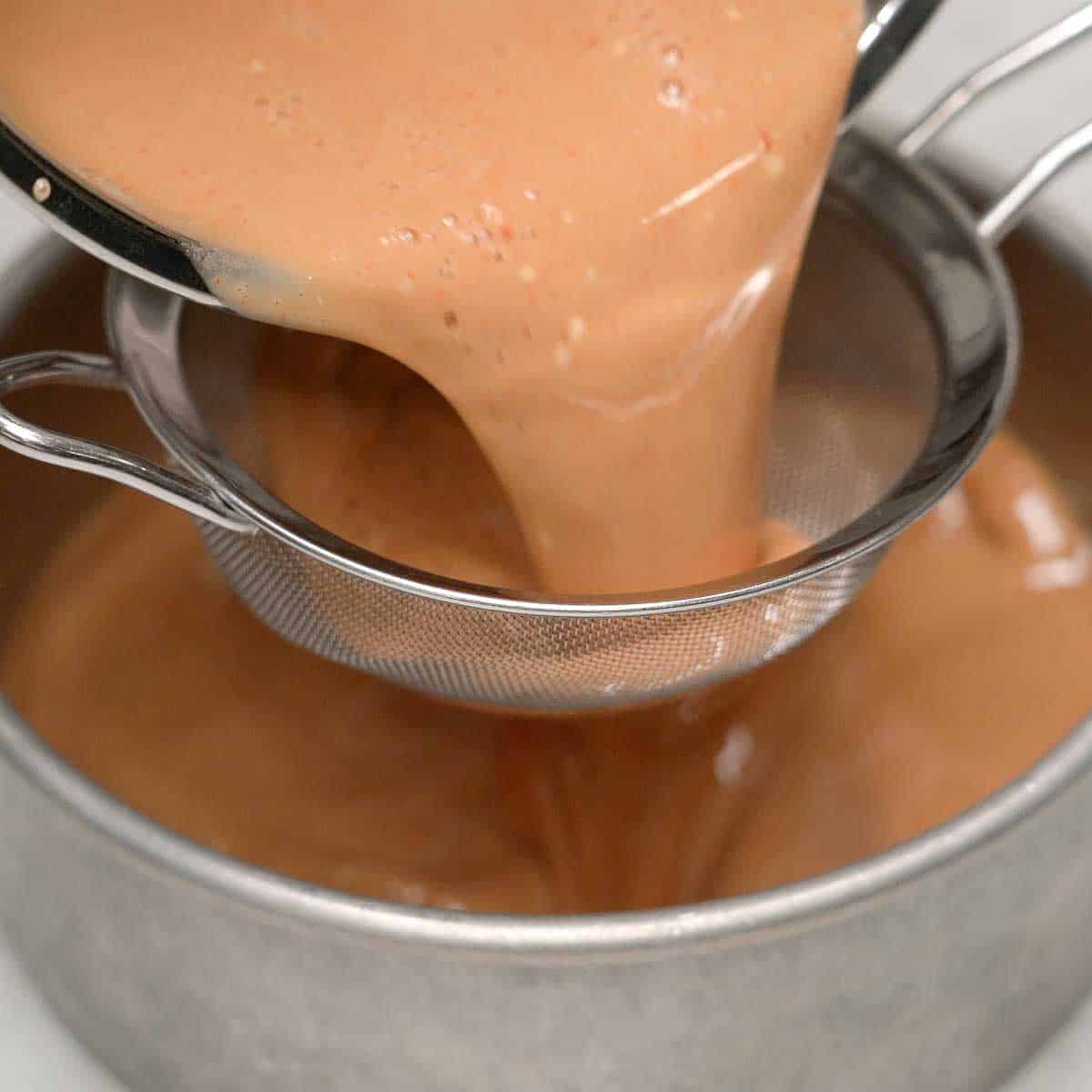 Straining the kutsinta bottom layer batter.