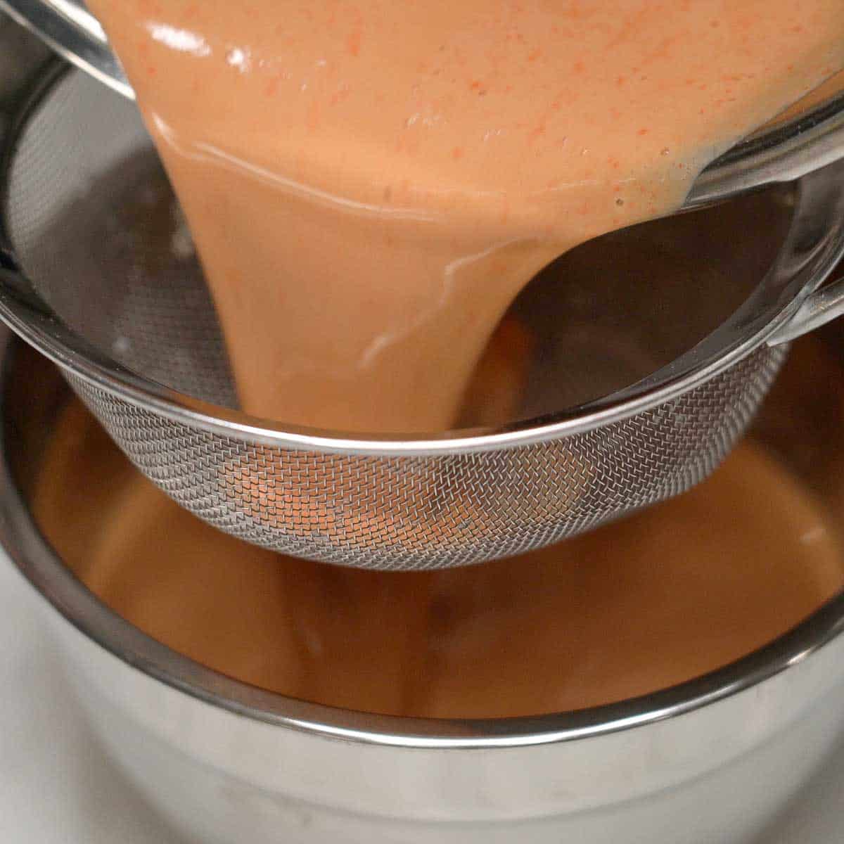 Straining the kutsinta top layer batter.