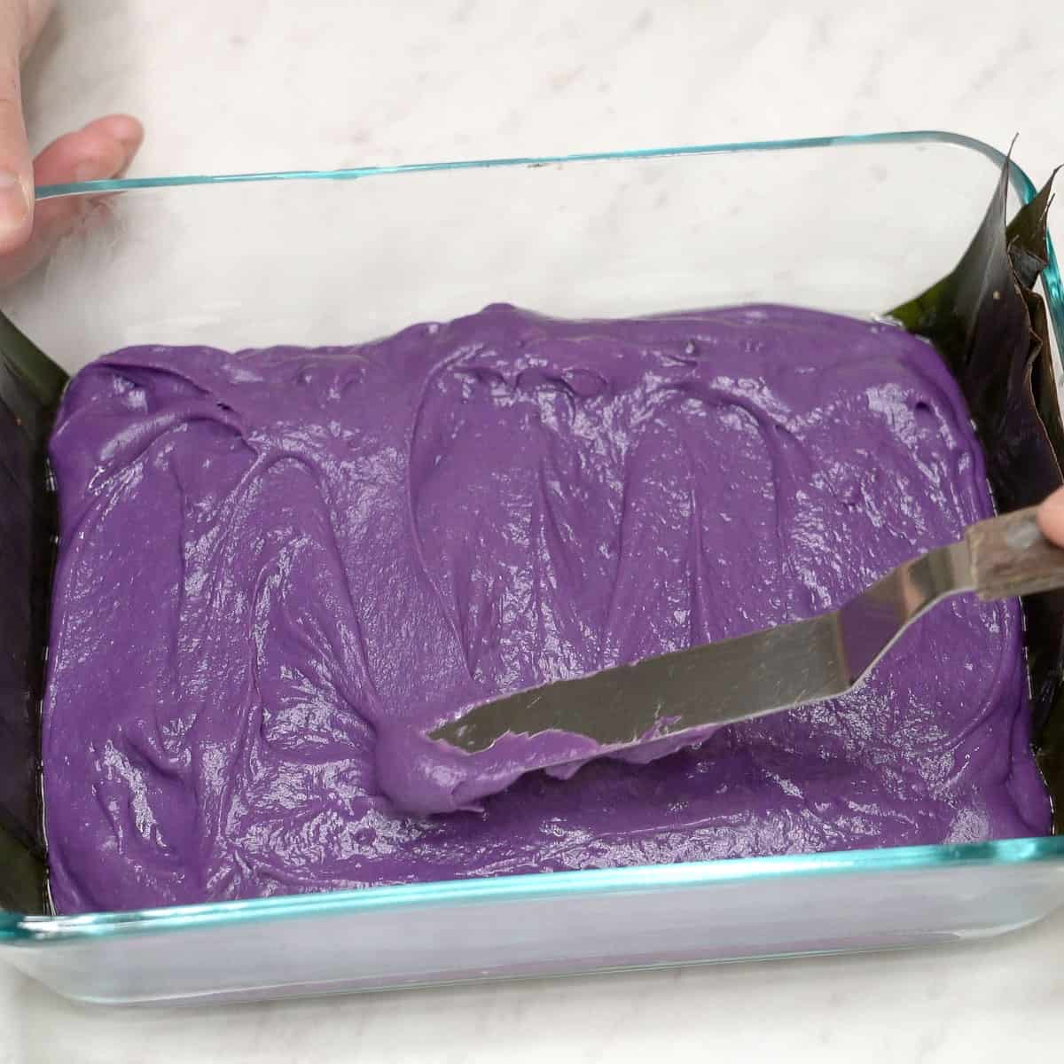 Smoothing the ube layer in the dish.