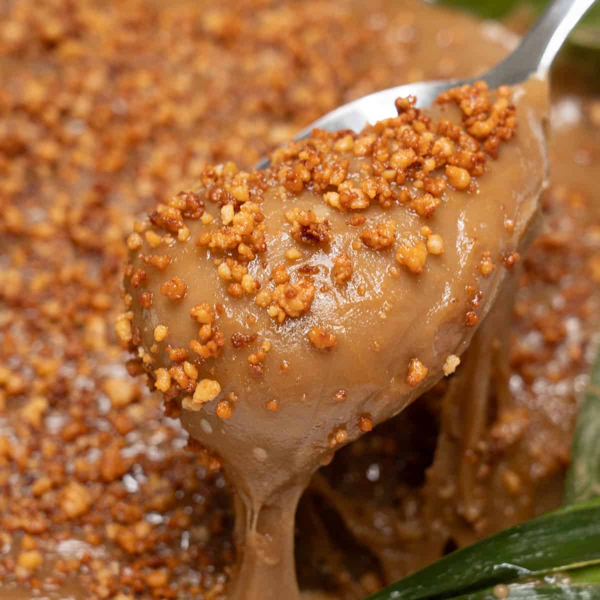 Kalamay hati with latik on a spoon.