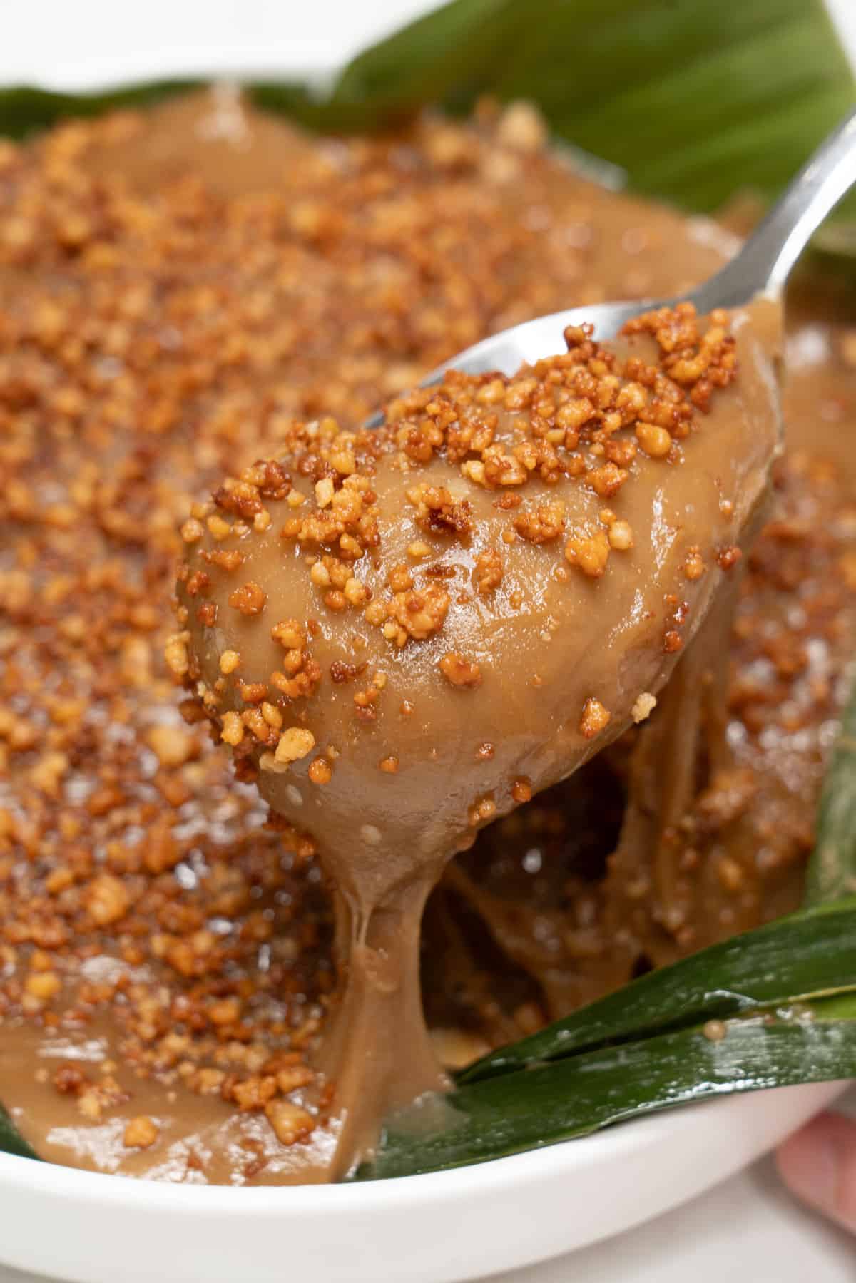 Scooping kalamay hati with a spoon.