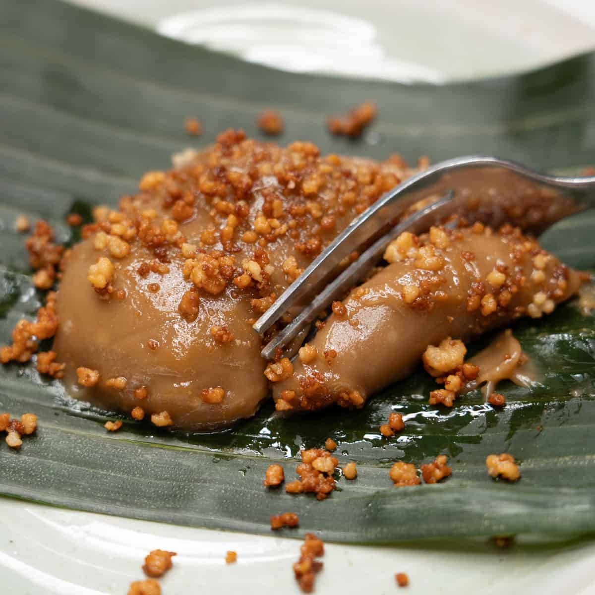 Cutting kalamay hati with a fork.