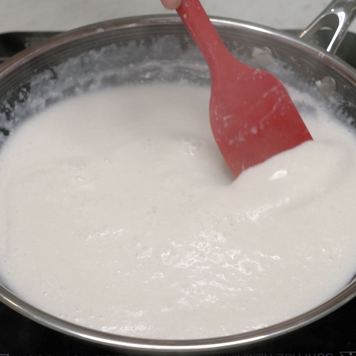 Mixing coconut cream in a pan.