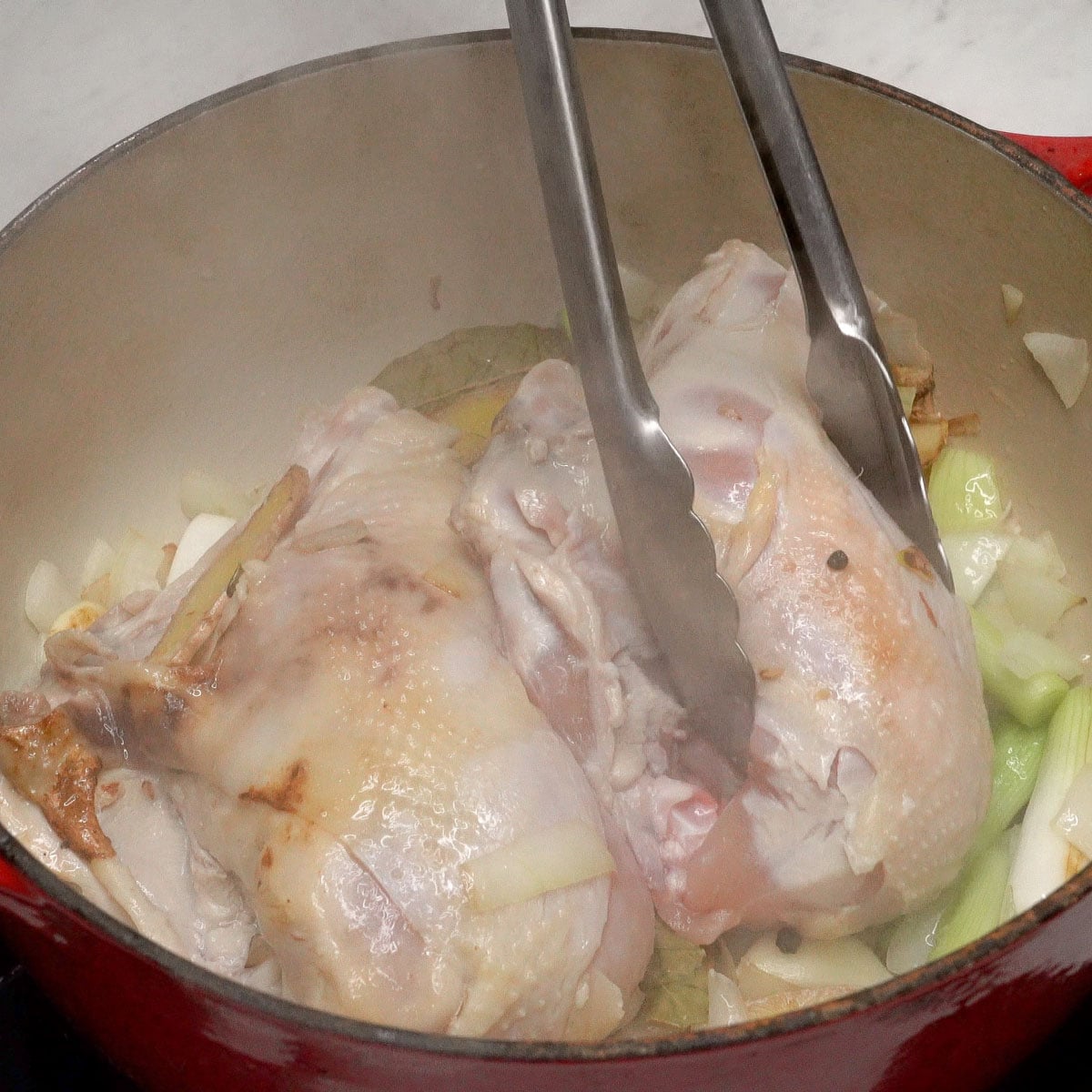 Browning the chicken breasts in the pot with aromatics.