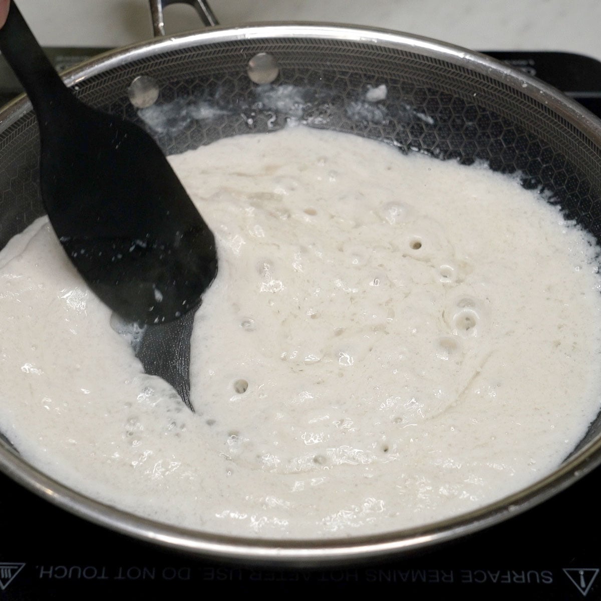 Mixing the coconut cream in the pan.