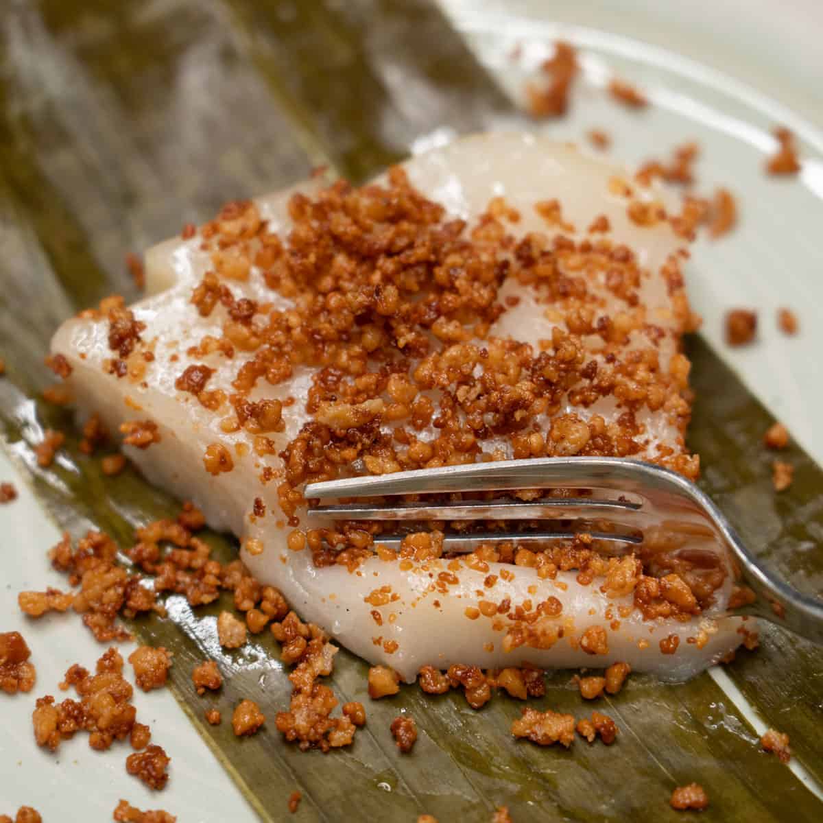 Cutting a slice of kalamay lansong with a fork.