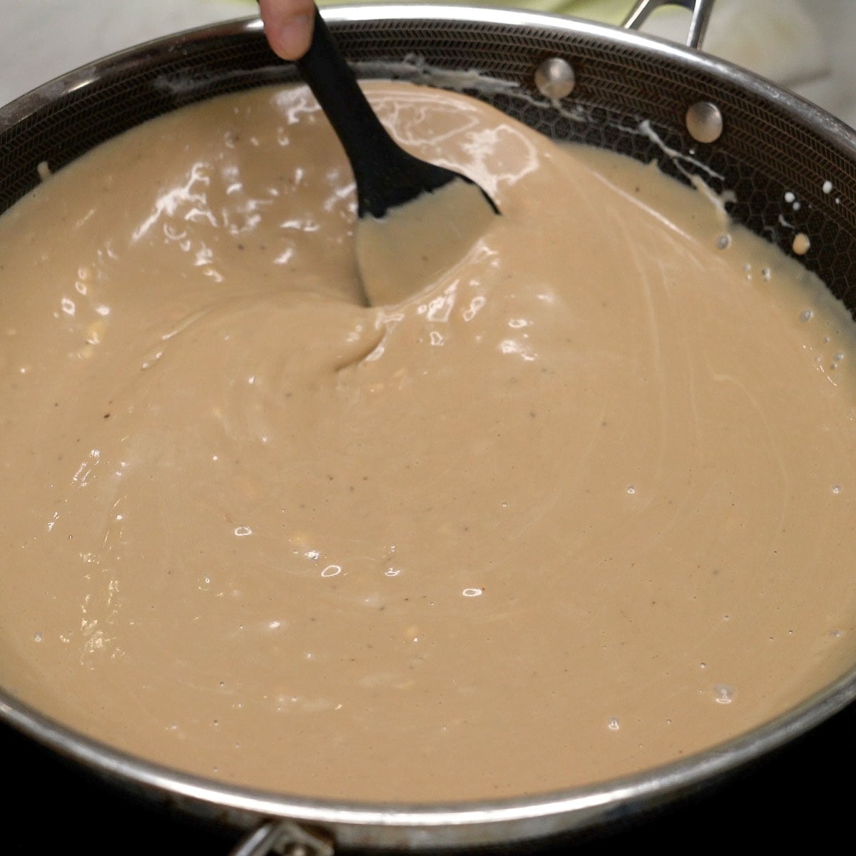 Mixing kalamay hati in the pan.