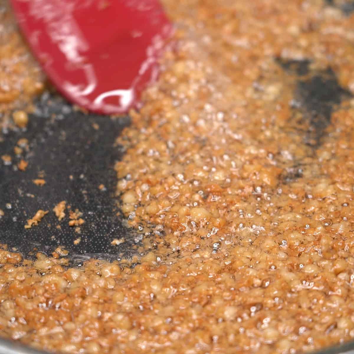 Cooking latik in a pan.