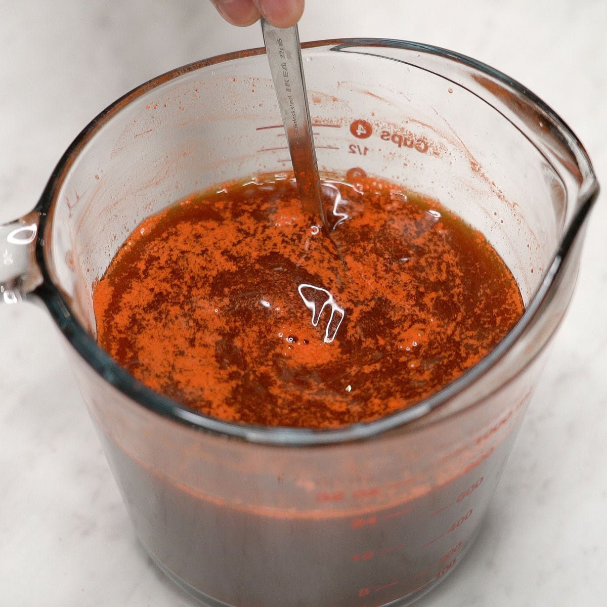Mixing the sauce ingredients in a cup.