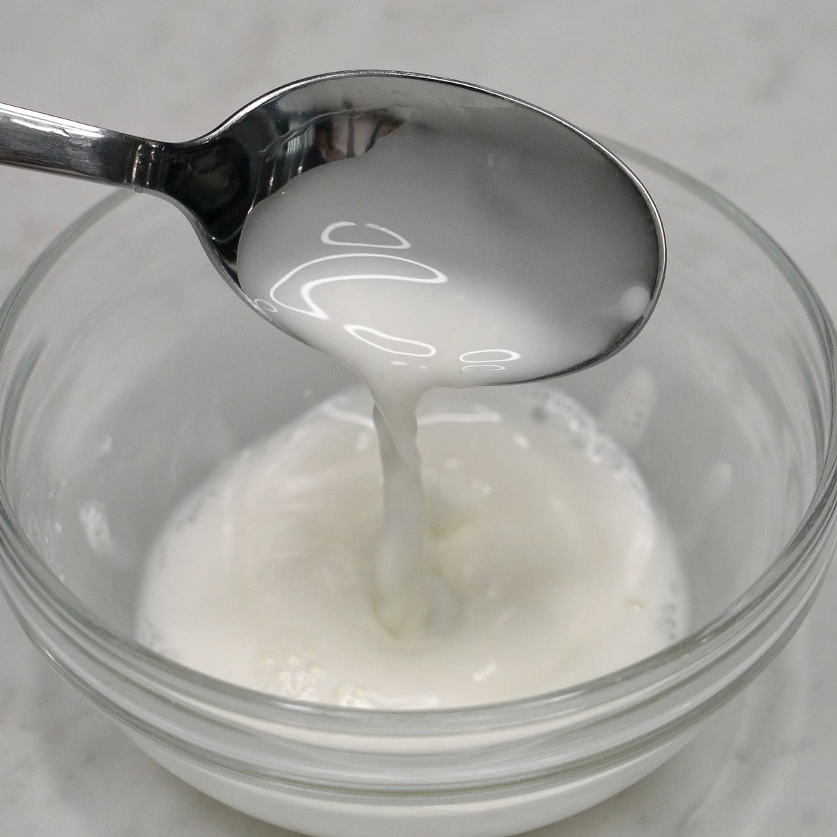 Mixing cornstarch slurry in a bowl.