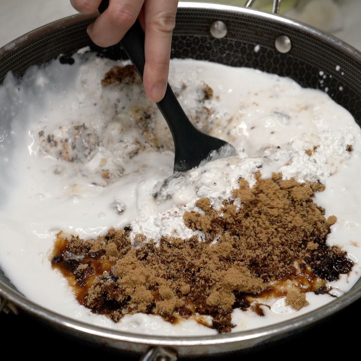 Mixing kalamay hati ingredients in the pan.