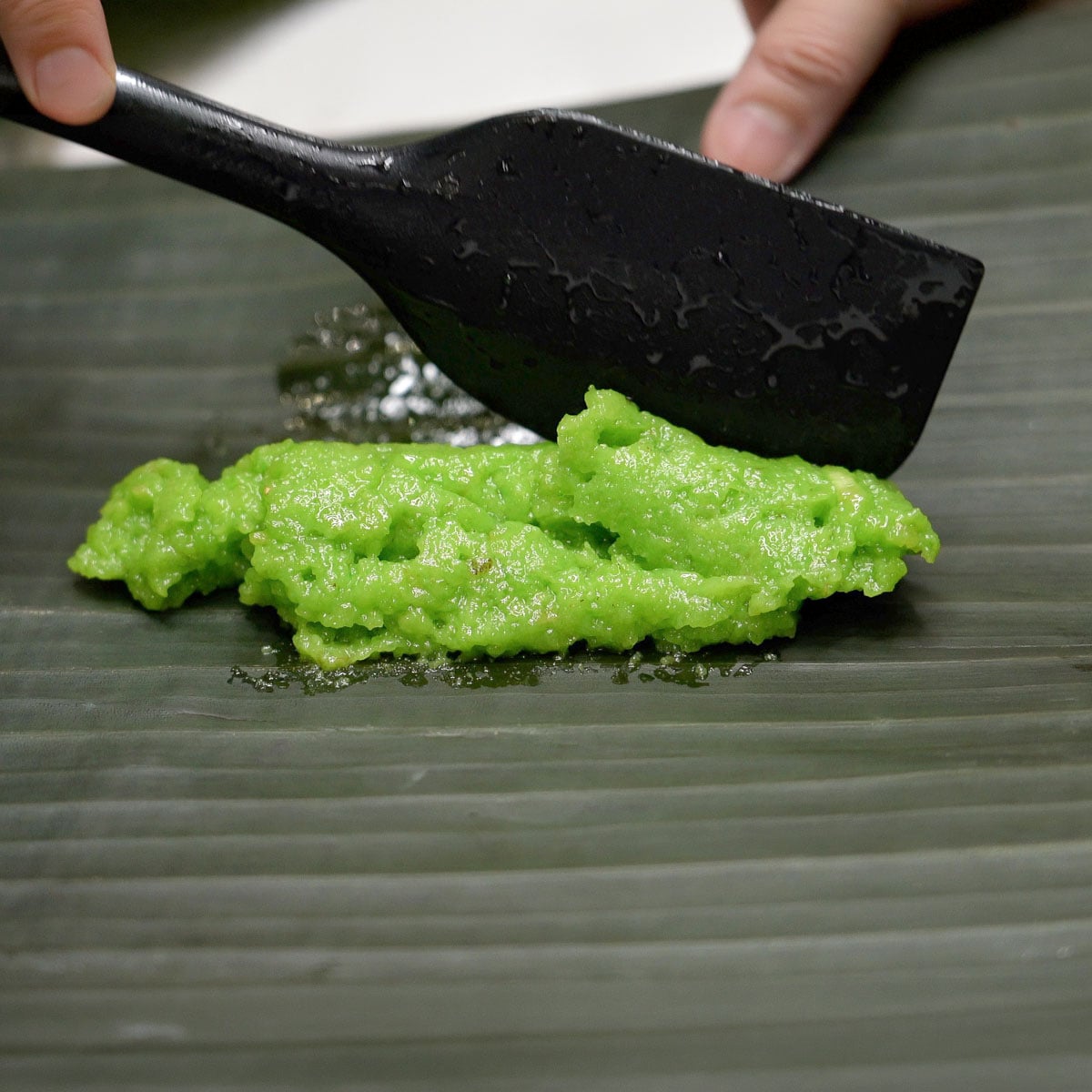 Suman pinipig portion on a banana leaf.