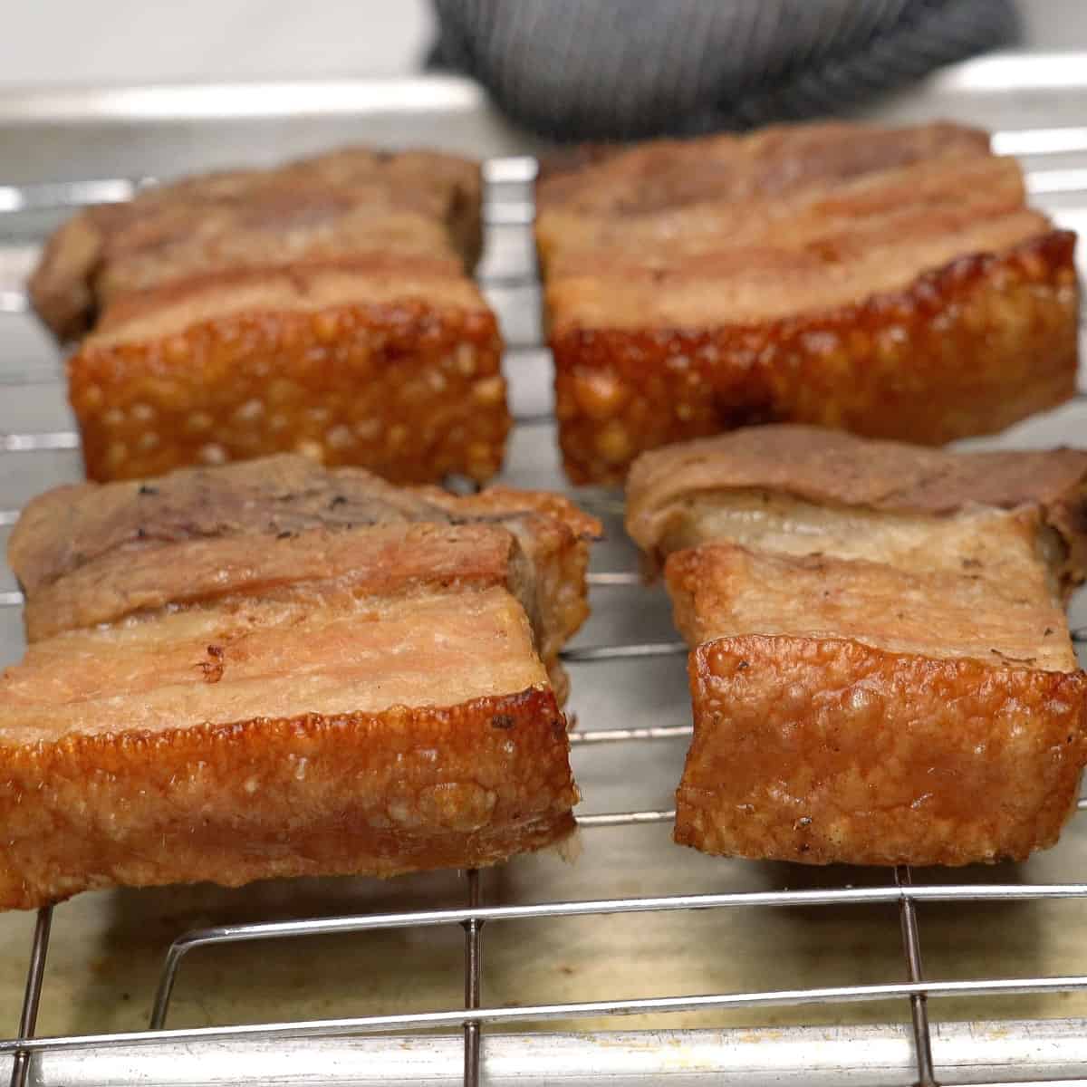 Air-fried pork belly on a wire rack.