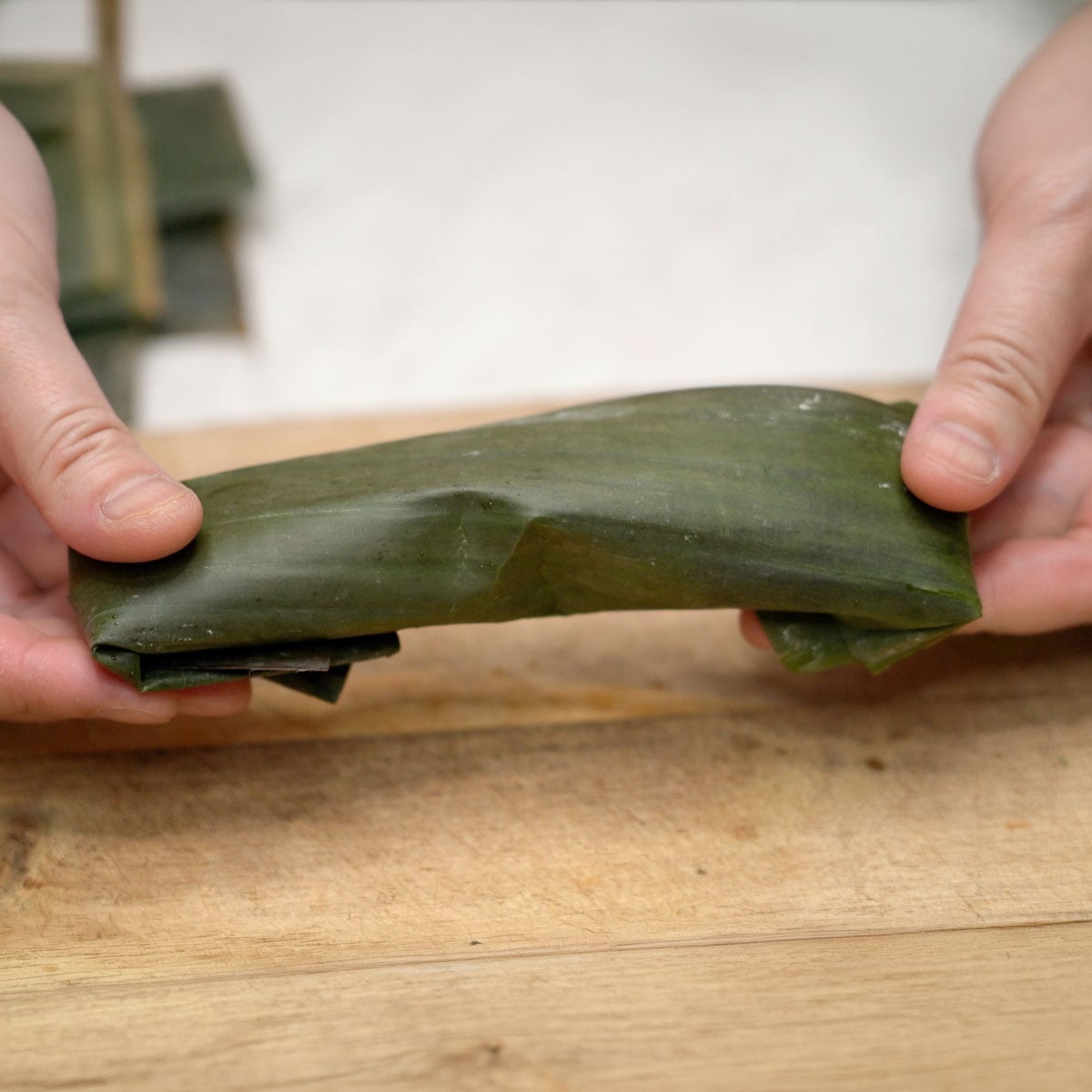 Suman pinipig wrapped in banana leaves.