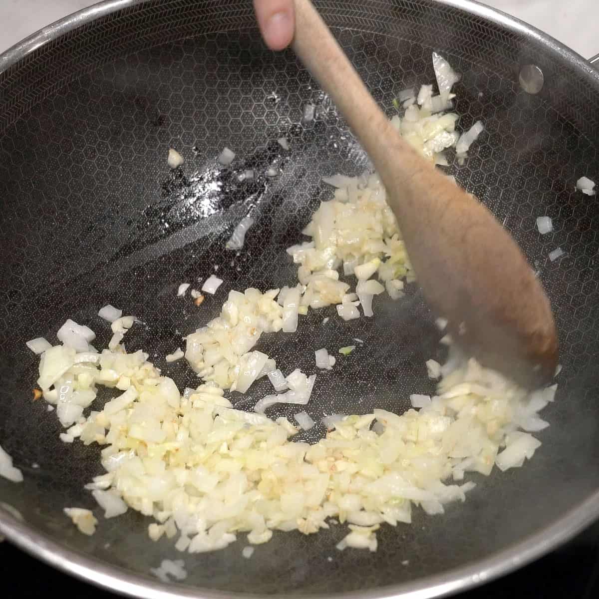 Sauteing aromatics in a wok.