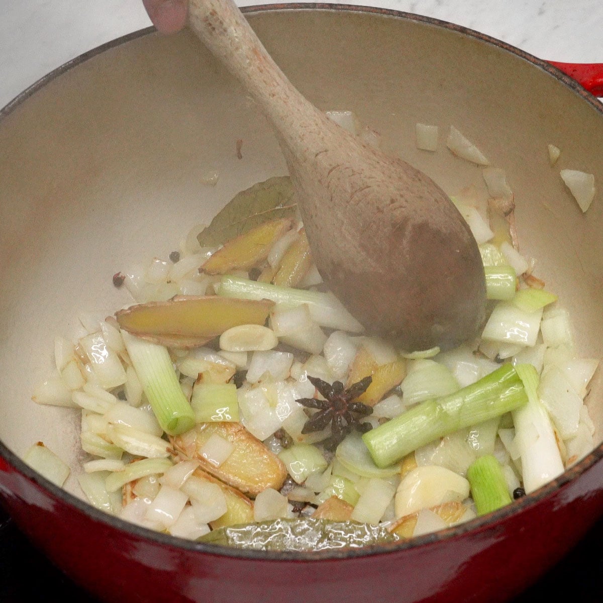 Sauteing aromatics in a pot.