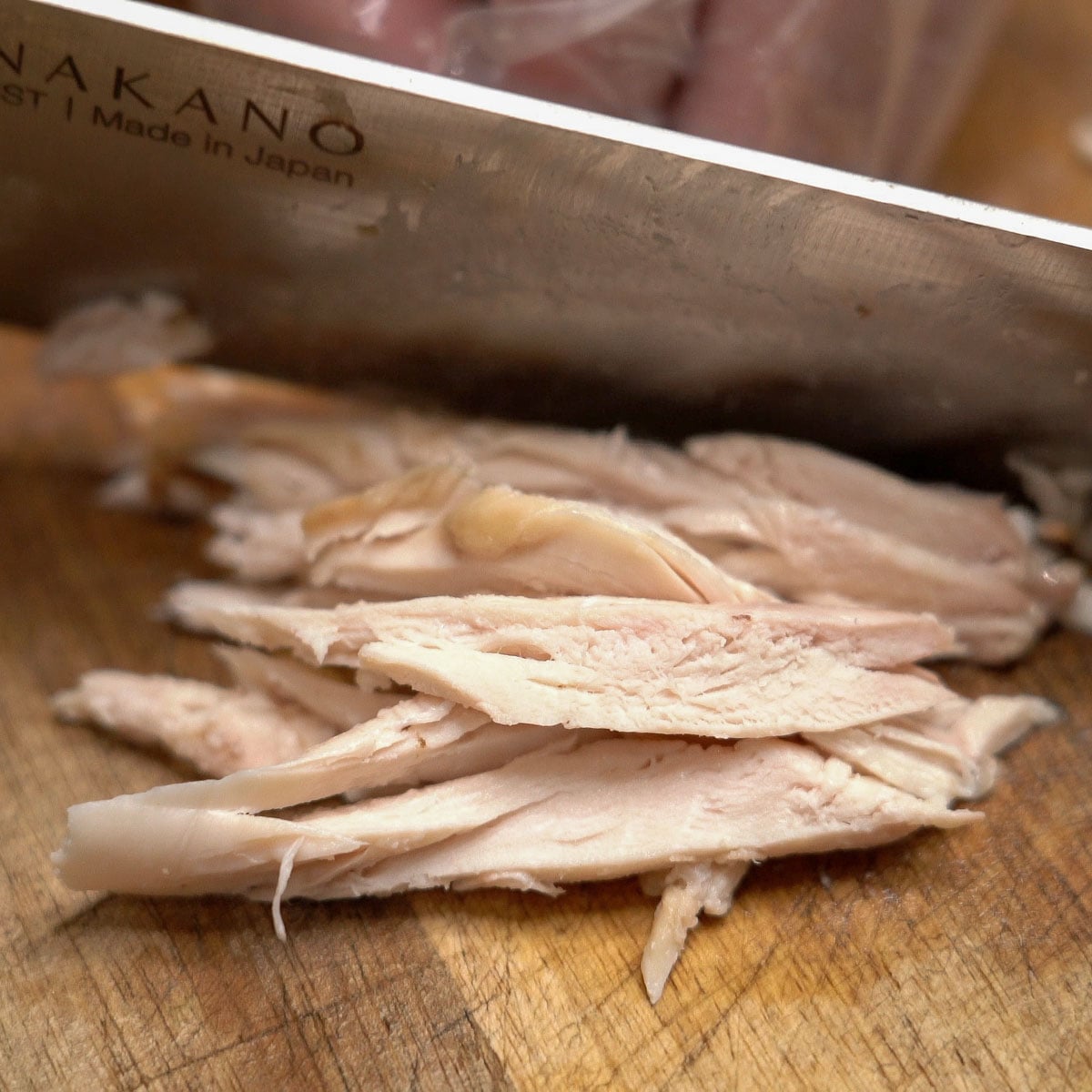 Slicing the chicken on a cutting board.