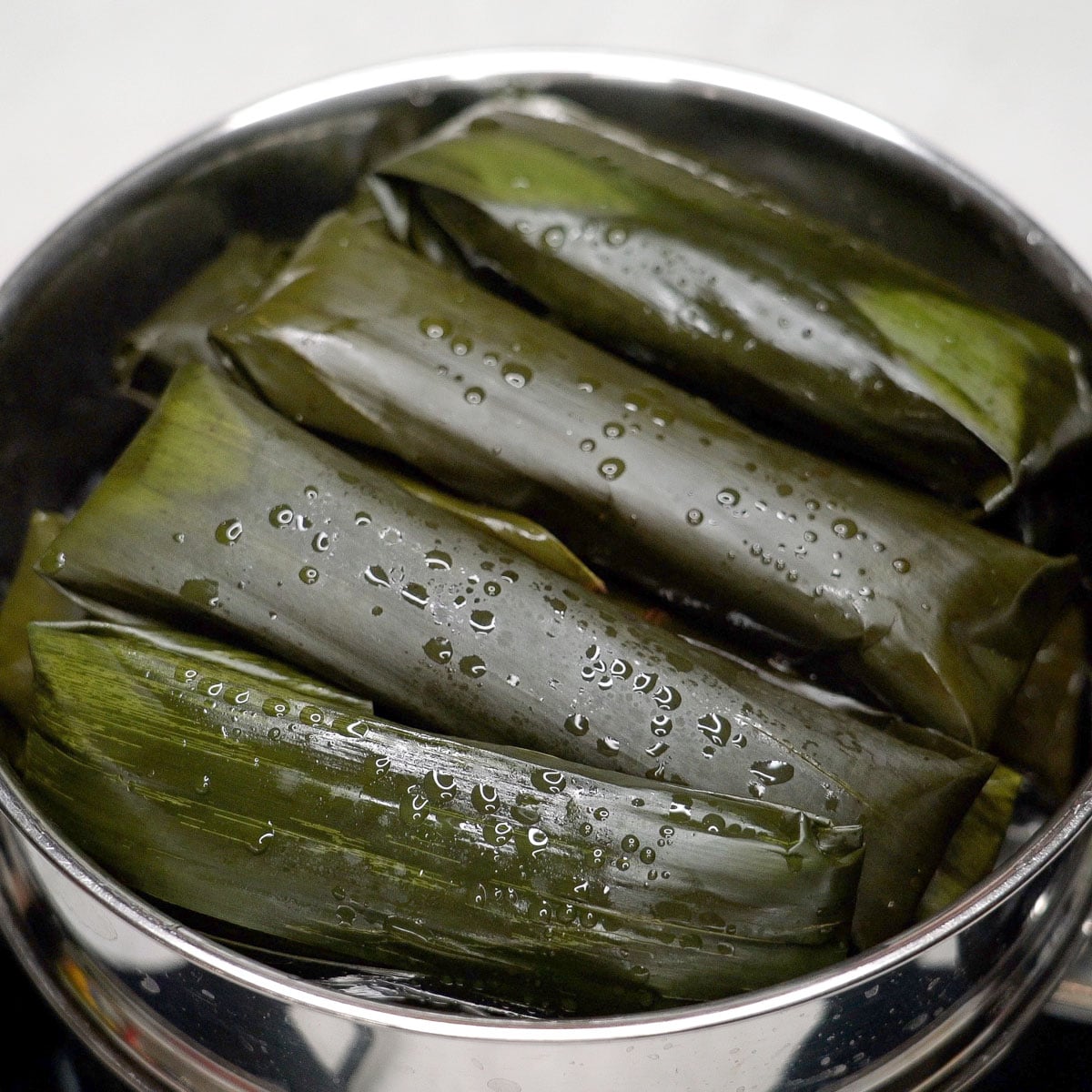 Steamed suman pinipig in a pot.