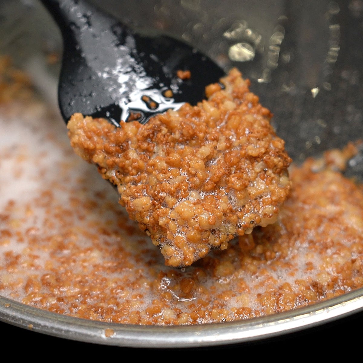 Cooked latik on a spatula.