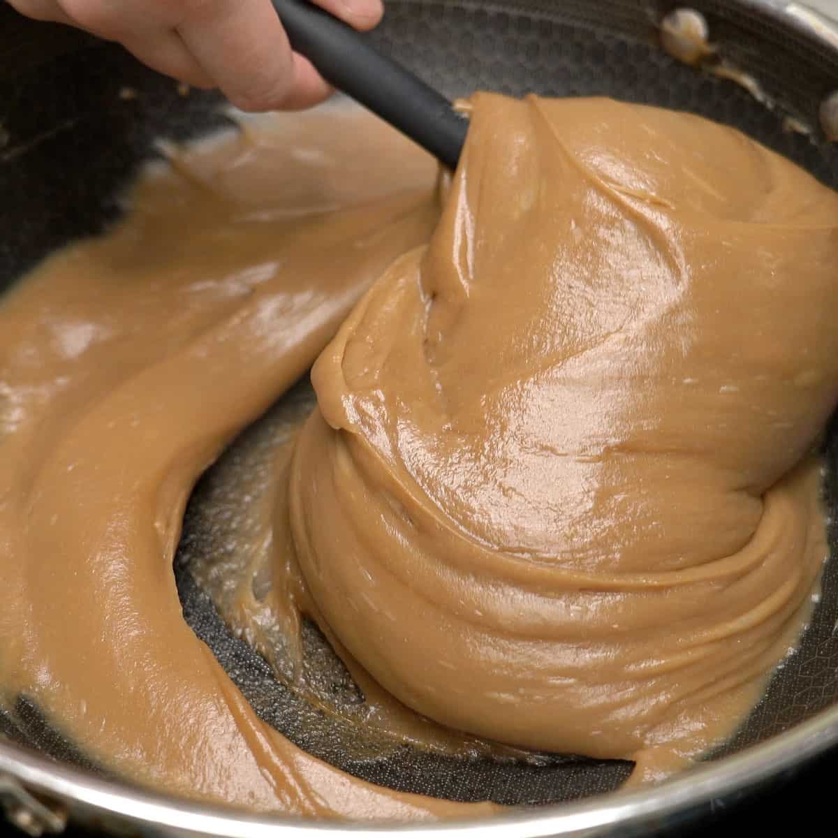 Kalamay hati starting to thicken in the pan.