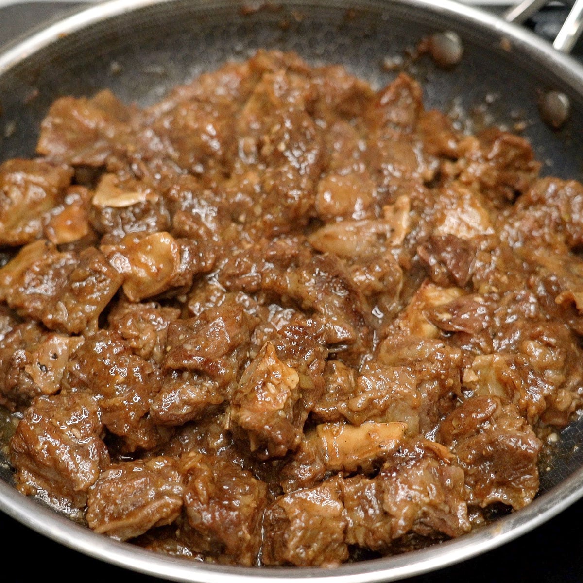 Cooking the beef in the pan.