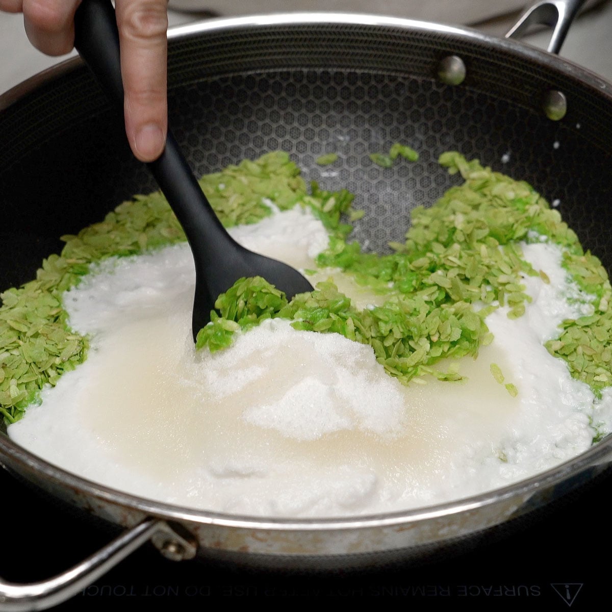 Mixing pinipig and other ingredients in the wok.