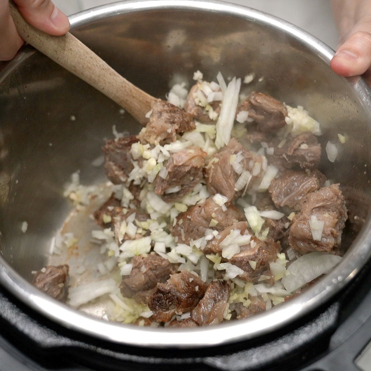 Sauteing the aromatics with the beef in the pot.