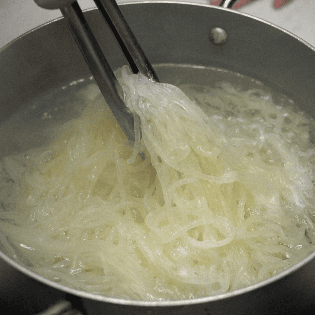 Loosening the noodles in the pot.
