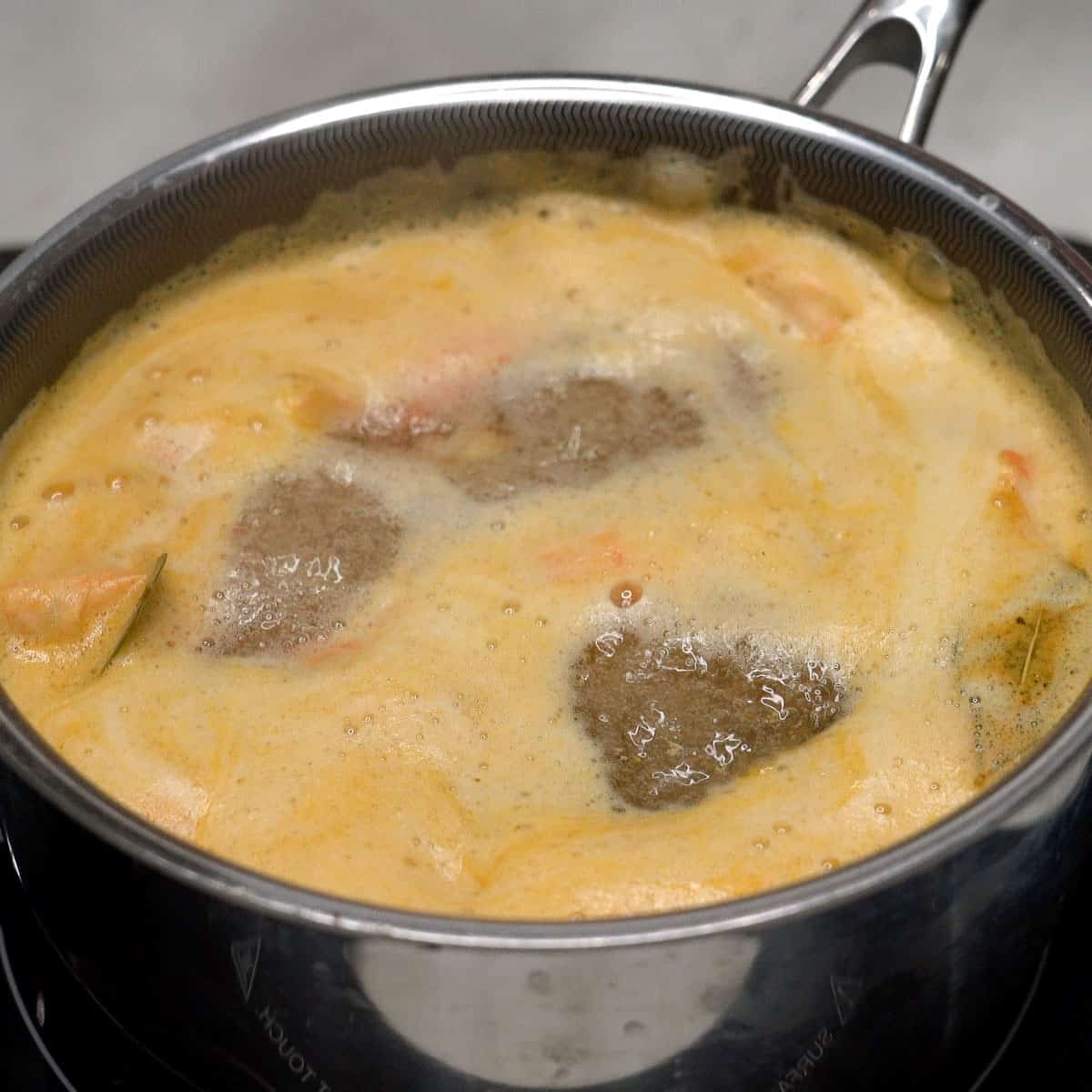 Boiling the shrimp stock in the pot.