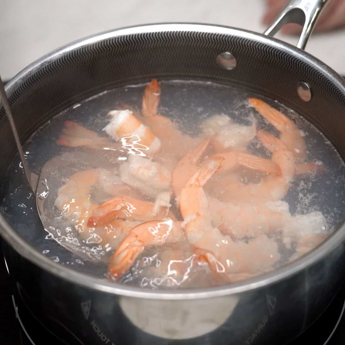 Cooking the shrimp in a pot of water.