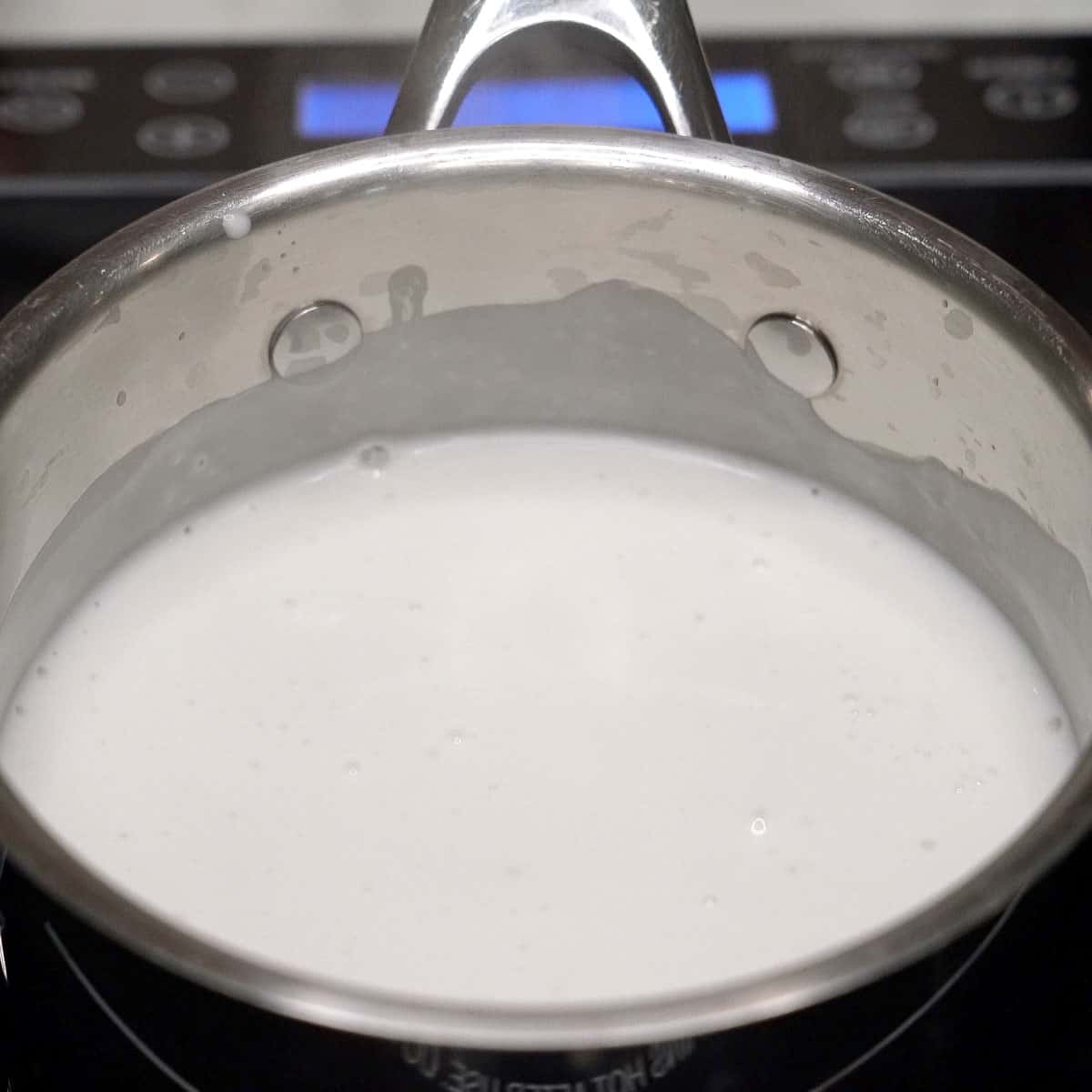 Coconut milk simmering in the pot.