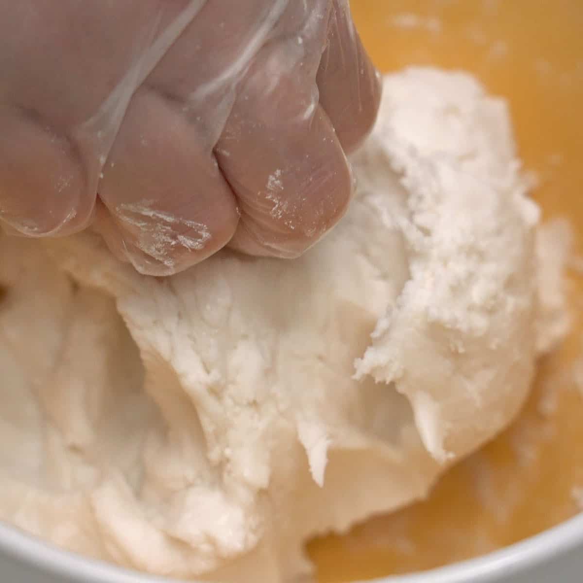 Mixing the carioca dough in a bowl.