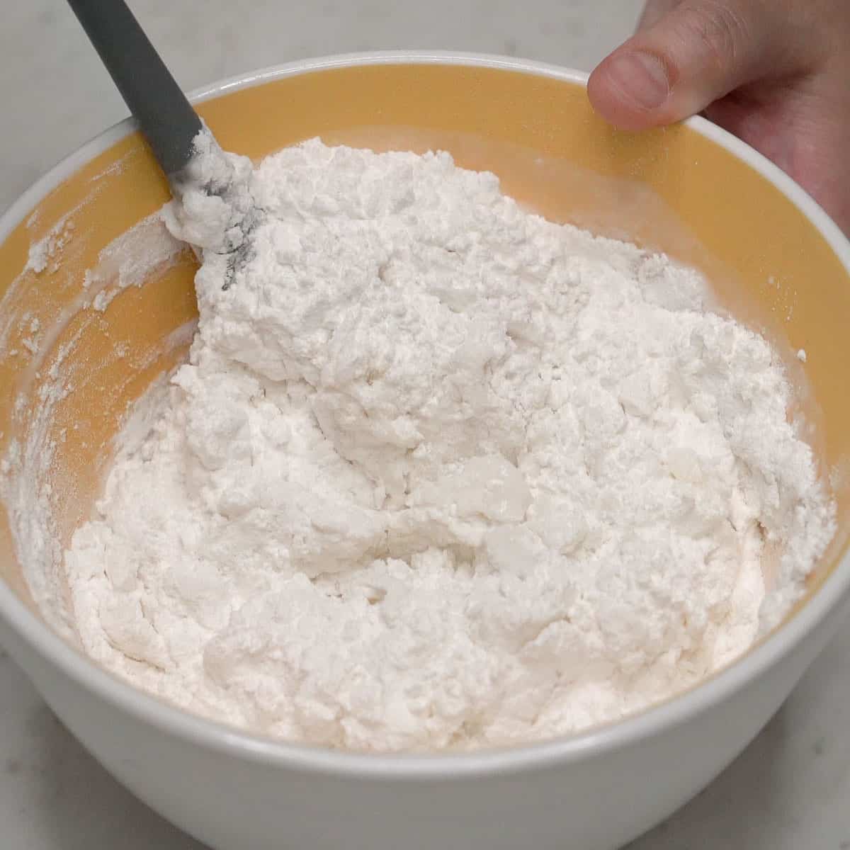 Mixing the dough ingredients in the bowl.