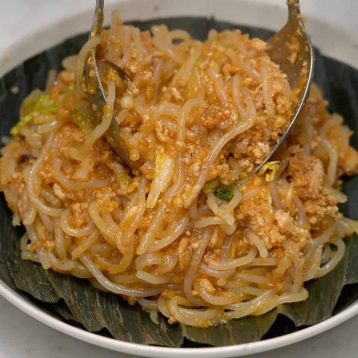 Pancit malabon on a banana leaf-lined plate.