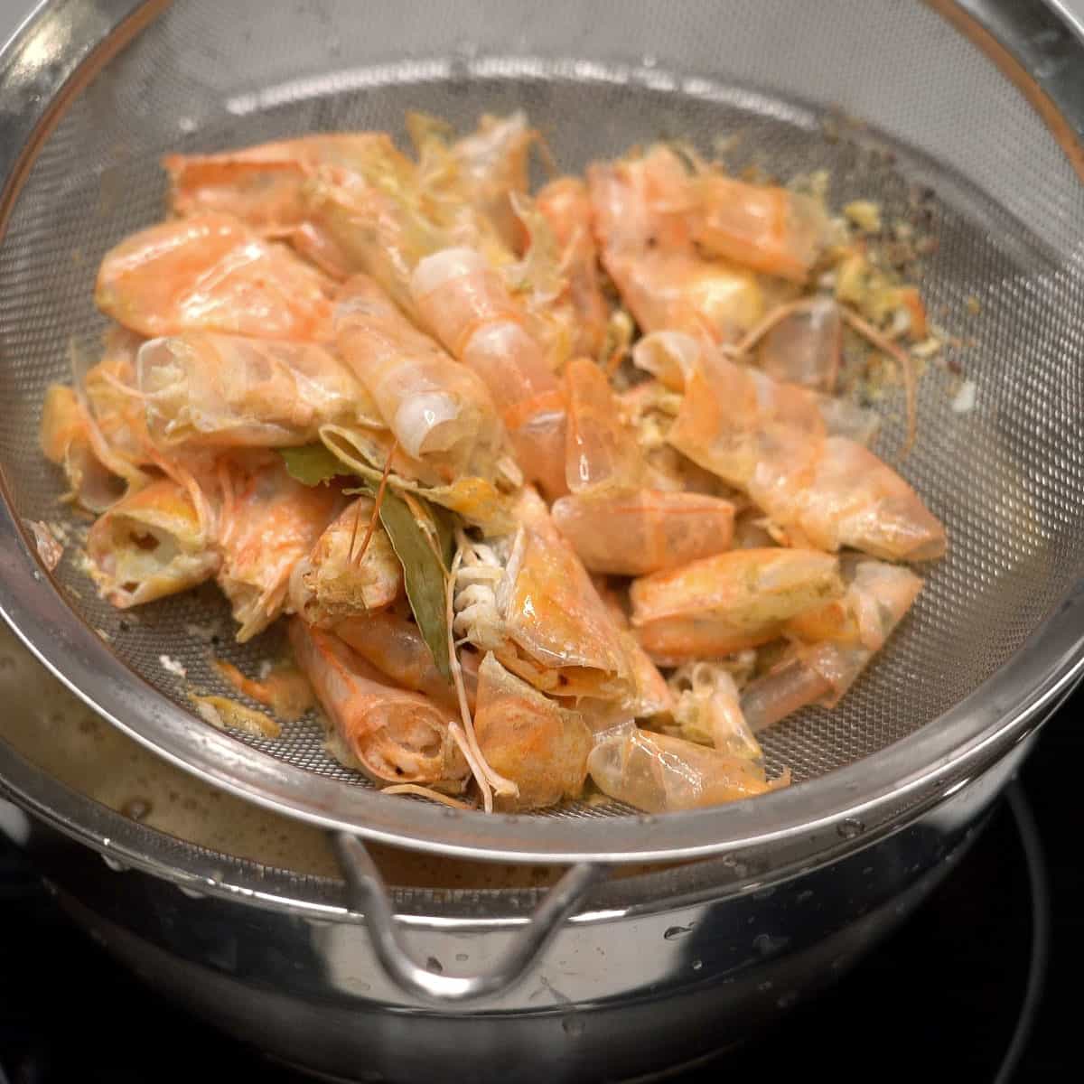Straining the shrimp broth.