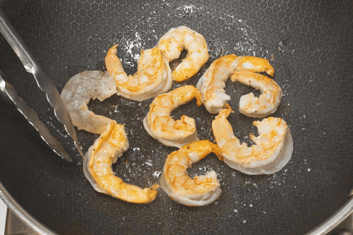 Searing the shrimp in the wok.