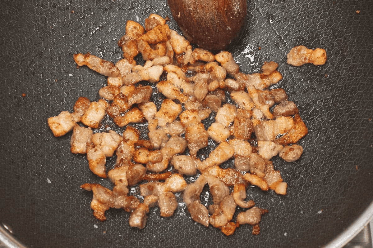 Browning the pork in the wok.