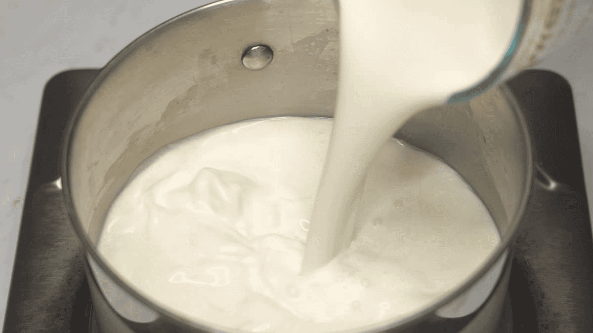 Combining the cream and other ingredients in a saucepan.