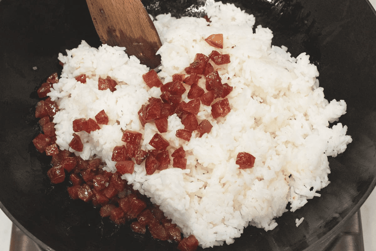 Added the white rice and Chinese sausage in the wok.