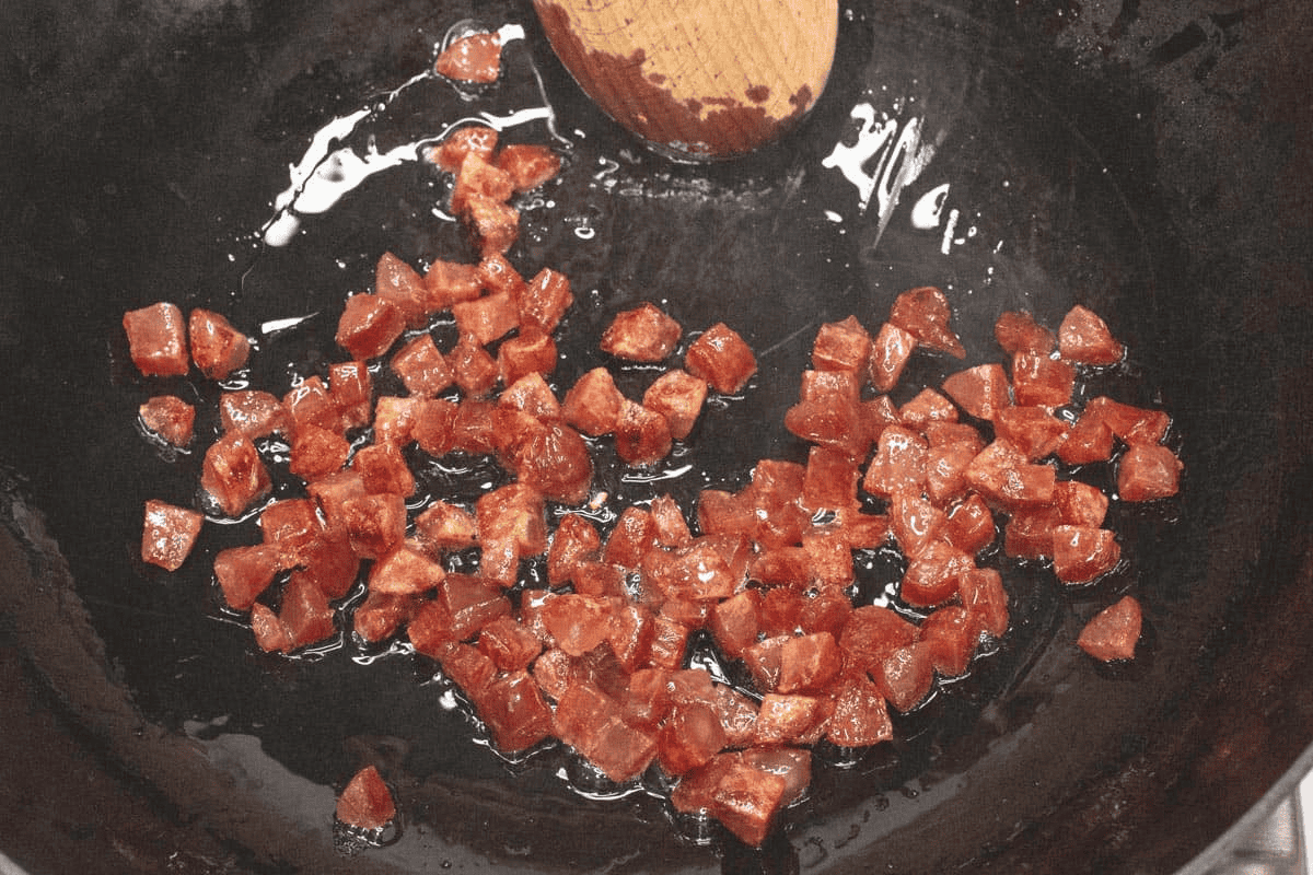 Browning the Chinese sausage in the wok.