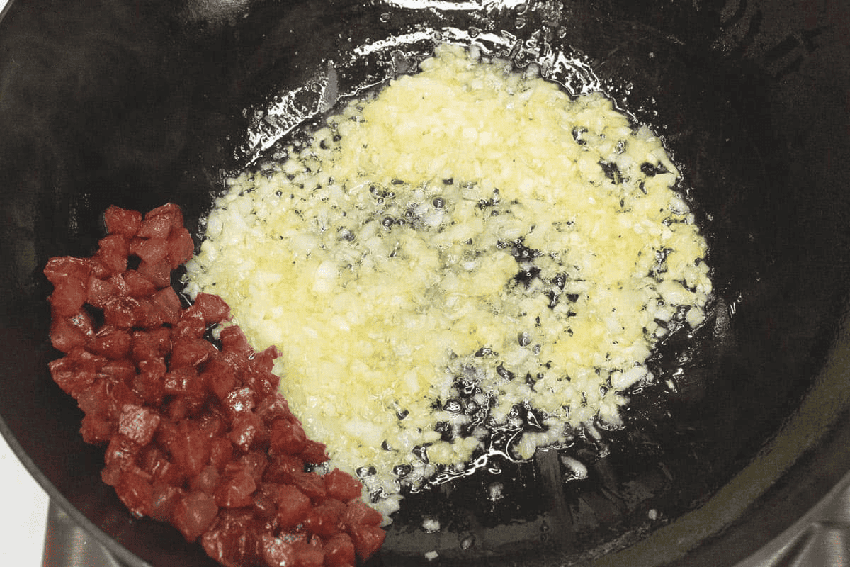 Sauteing the aromatics in the wok.