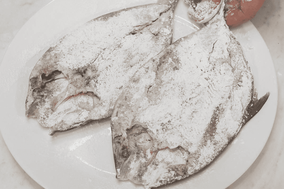 Coating the bangus with starch.