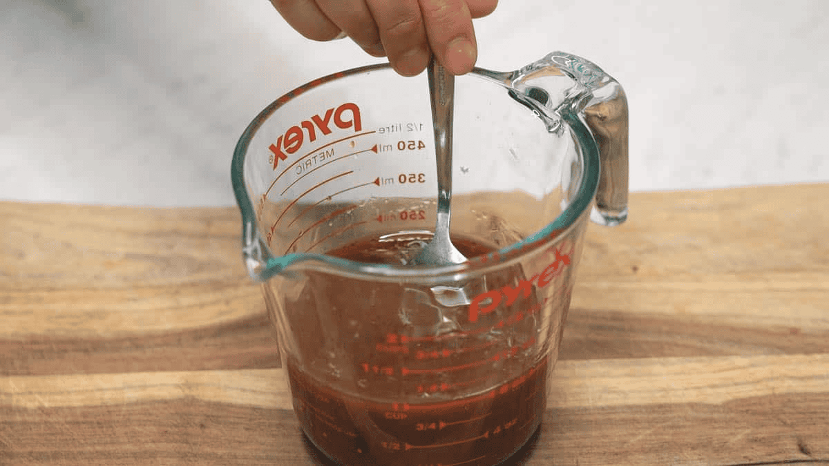 Mixing the stir fry sauce in a measuring cup.