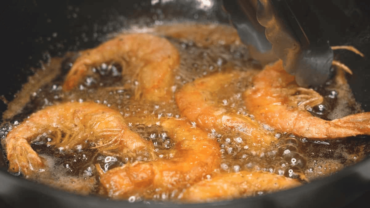 Frying the shrimp in the wok.