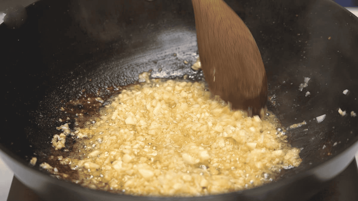 Sauteing ginger and garlic in the wok.