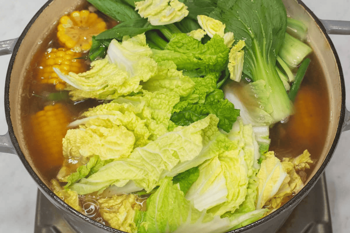 Added the bok choy and napa cabbage to the pot.