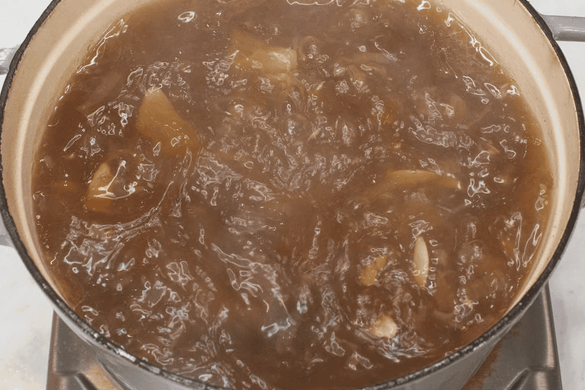 Simmering the mixture in the pot.