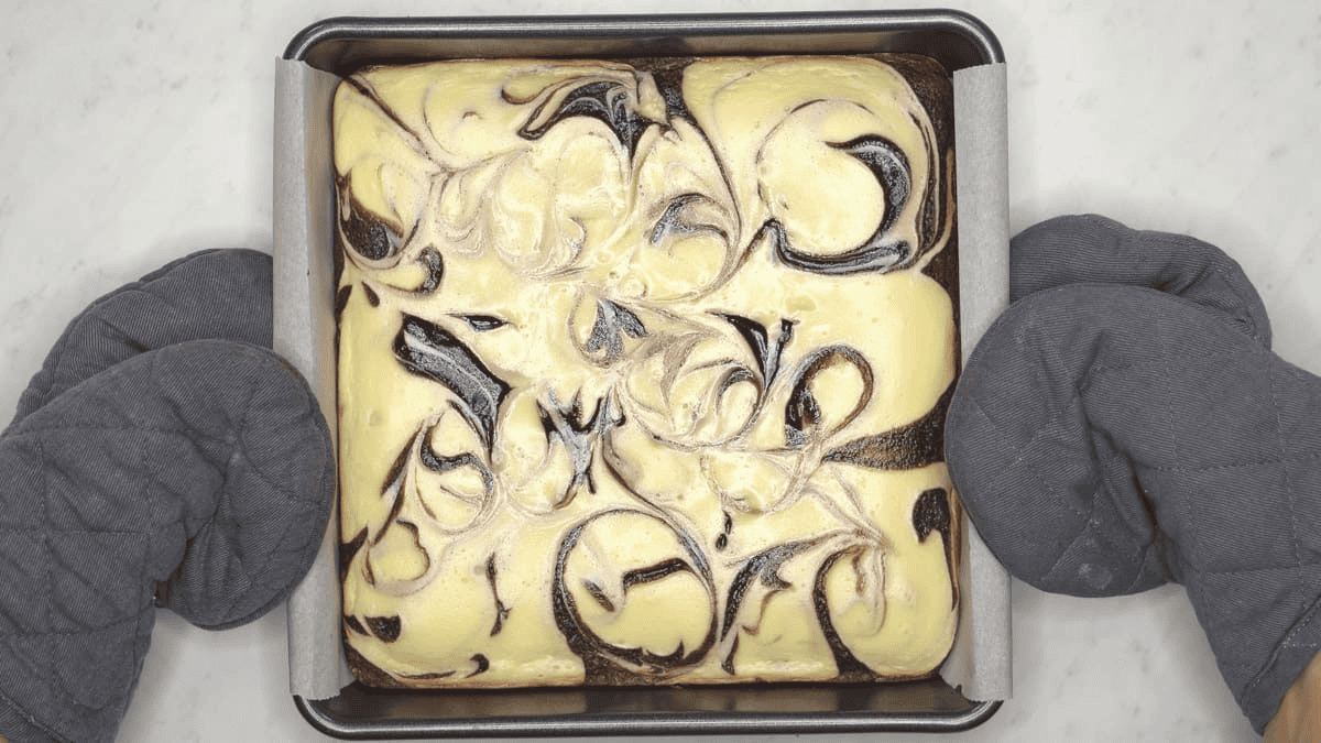 Baked cheesecake brownies in the pan.