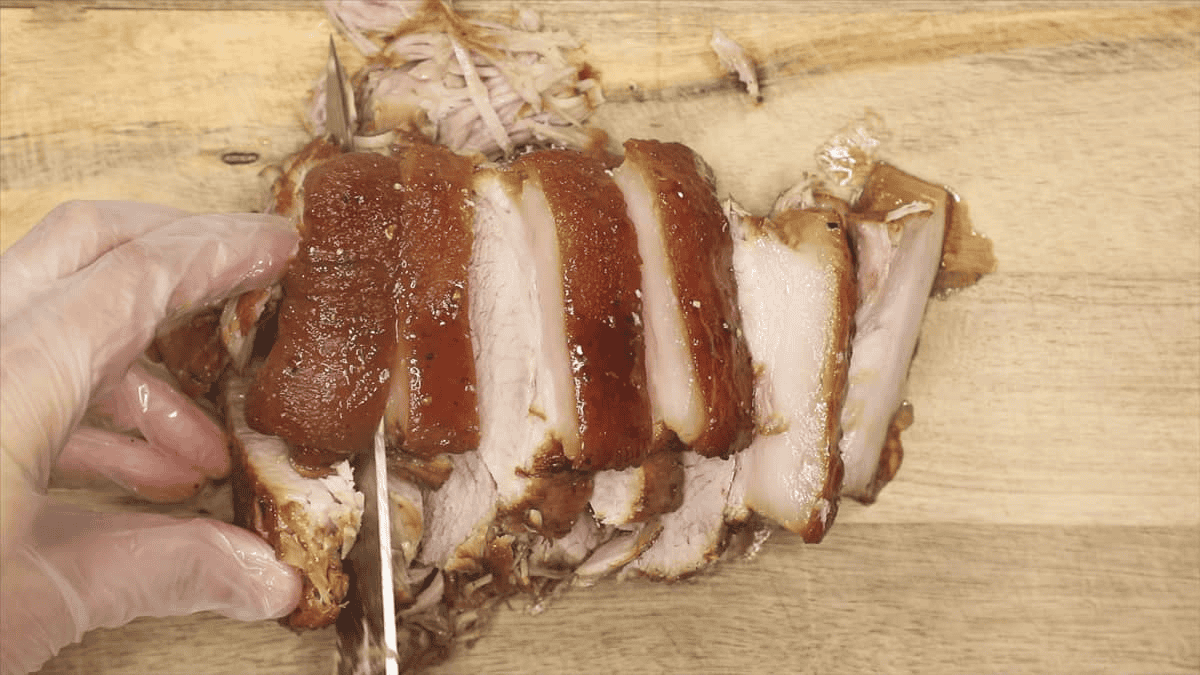 Slicing the meat on a cutting board.