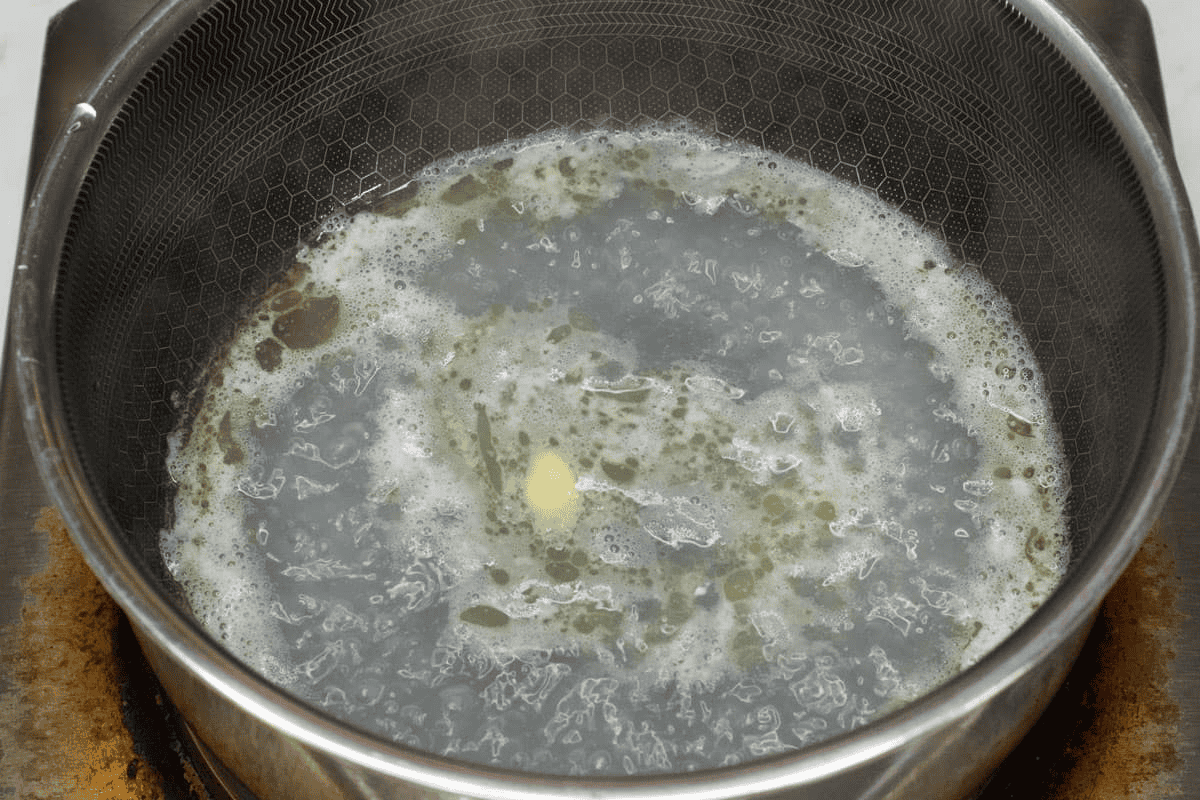 Boiling the water and butter in a saucepan.